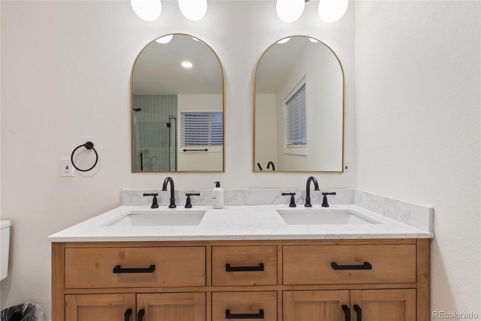 29 South Pine Drive Bailey, CO 80421 - Photo 15 of 27 a bathroom with a double vanity sink and a mirror