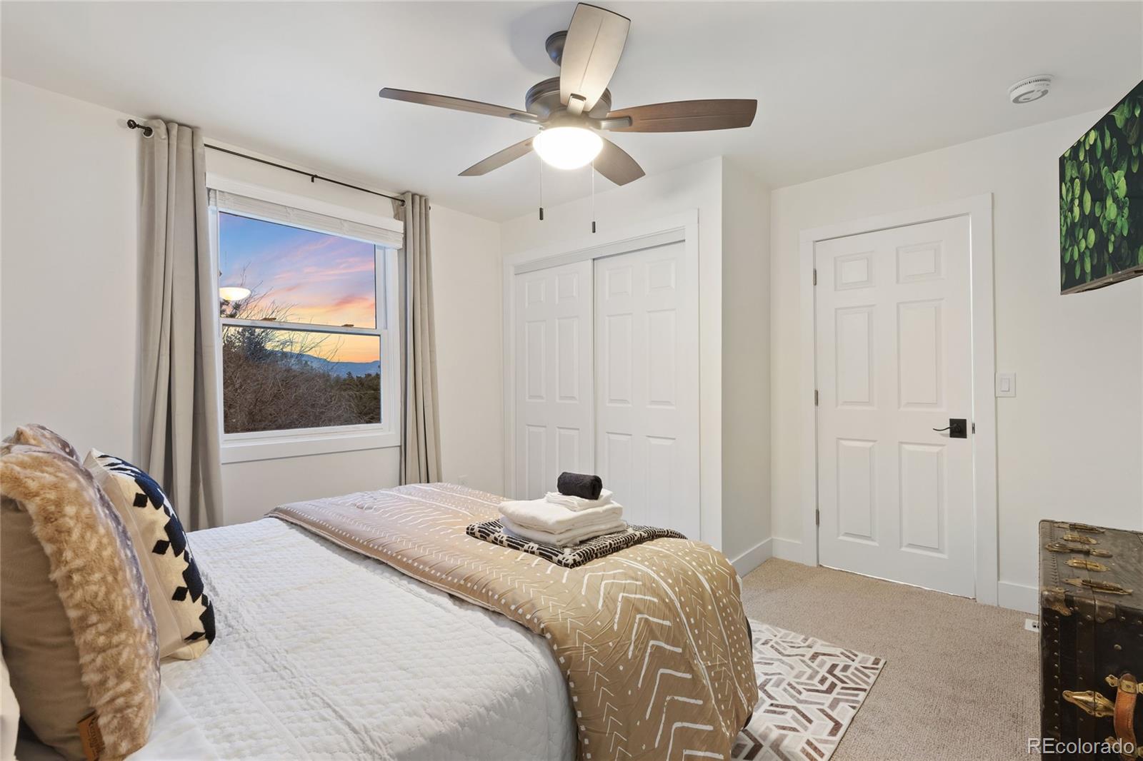 29 South Pine Drive Bailey, CO 80421 - Photo 17 of 27 a bedroom with a large bed and a window