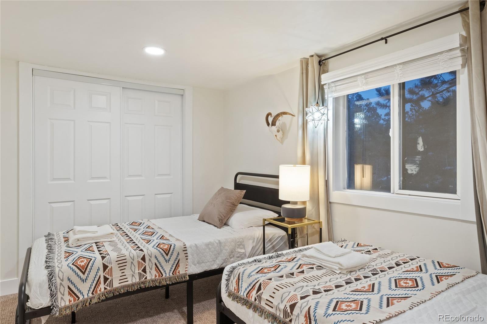 29 South Pine Drive Bailey, CO 80421 - Photo 19 of 27 a bedroom with a bed and wooden floor