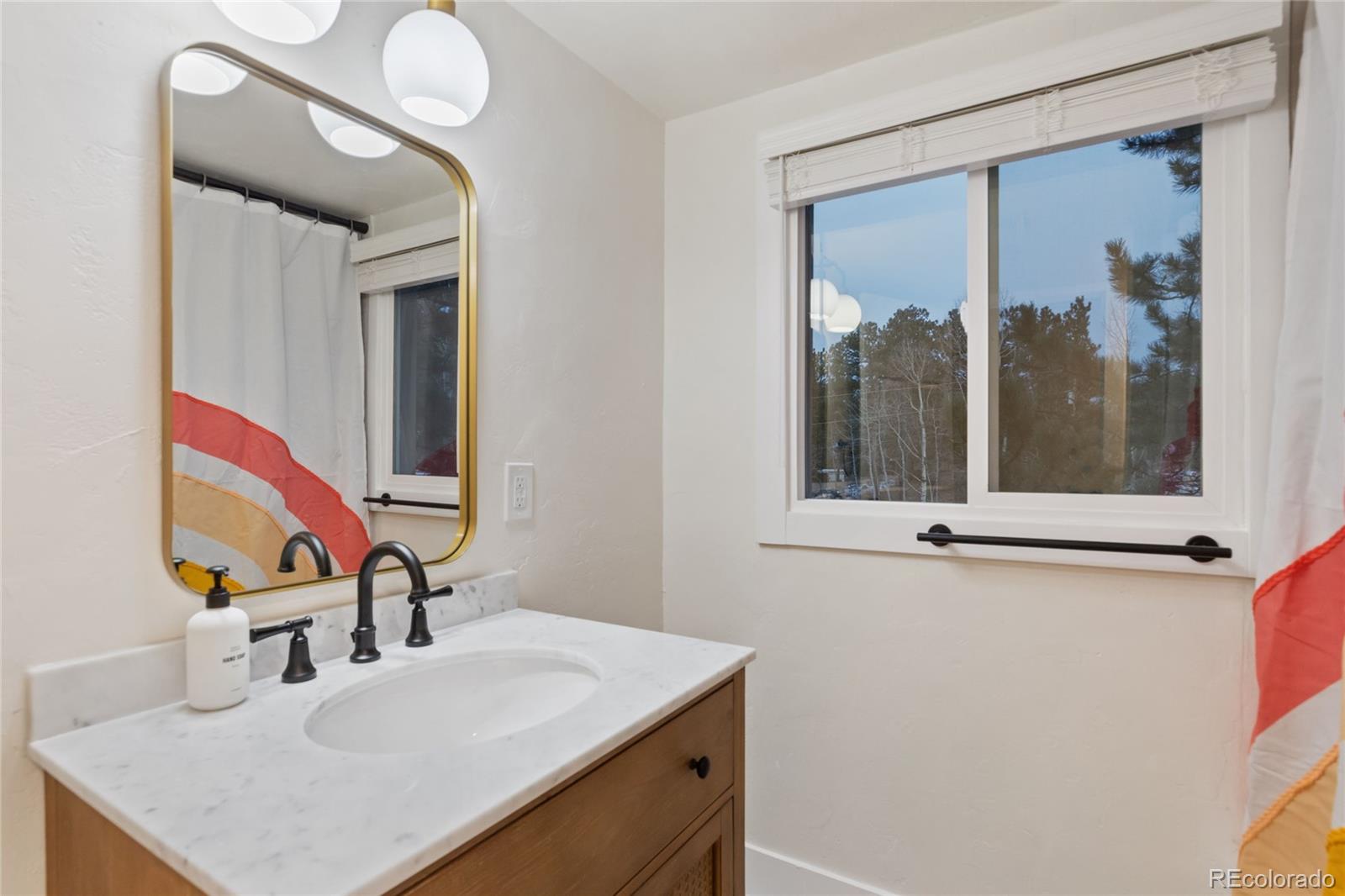 29 South Pine Drive Bailey, CO 80421 - Photo 22 of 27 a bathroom with a sink and a mirror