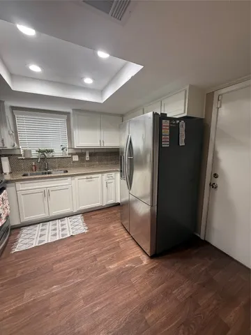 a kitchen with stainless steel appliances granite countertop a refrigerator and a sink