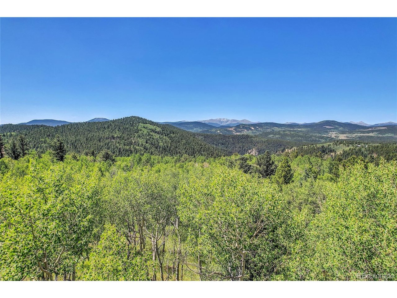 9 Hughesville Road Black Hawk, CO 80422 - Photo 12 of 17 a view of a lush green hillside and a building