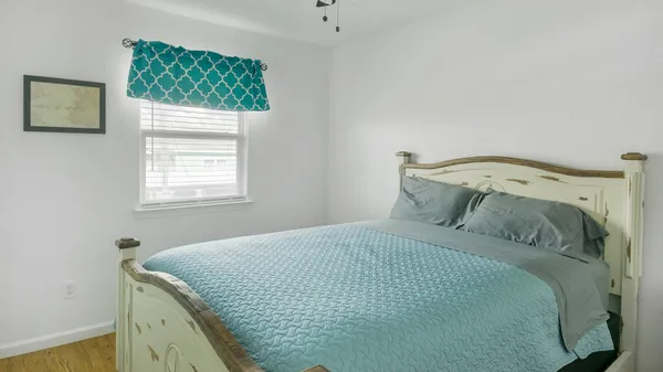 a bedroom with a bed and a window