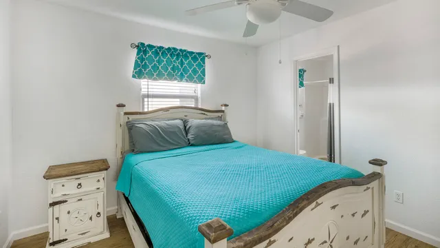 a bedroom with a bed and a window