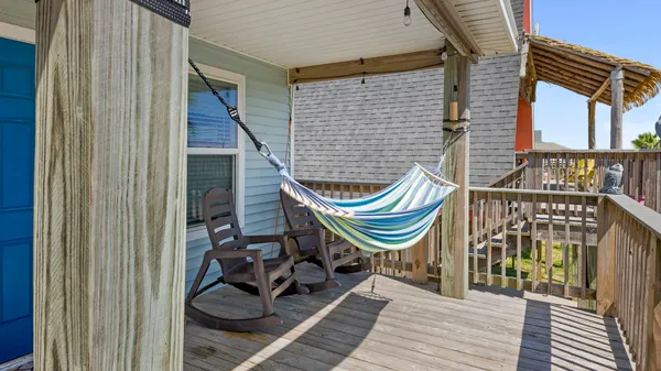 a view of a two chairs in the balcony