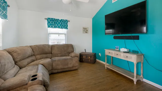 a living room with furniture and a flat screen tv