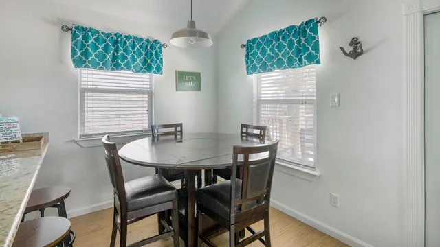 a view of a dining room with furniture window and wooden floor