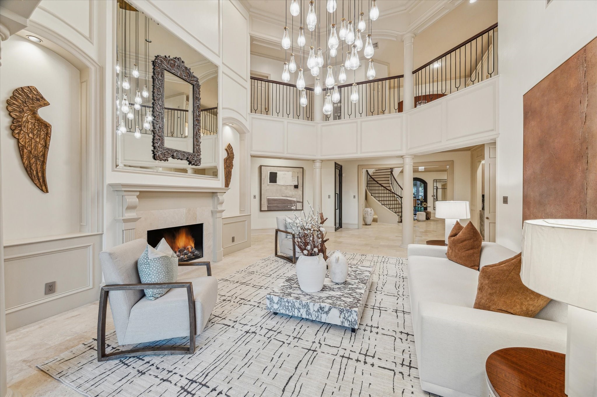 918 Huntington Cove Houston, TX 77063 - Photo 13 of 50 Impressive grand formal living room centered around a stone mantle over a cozy fireplace creating an inviting focal point.