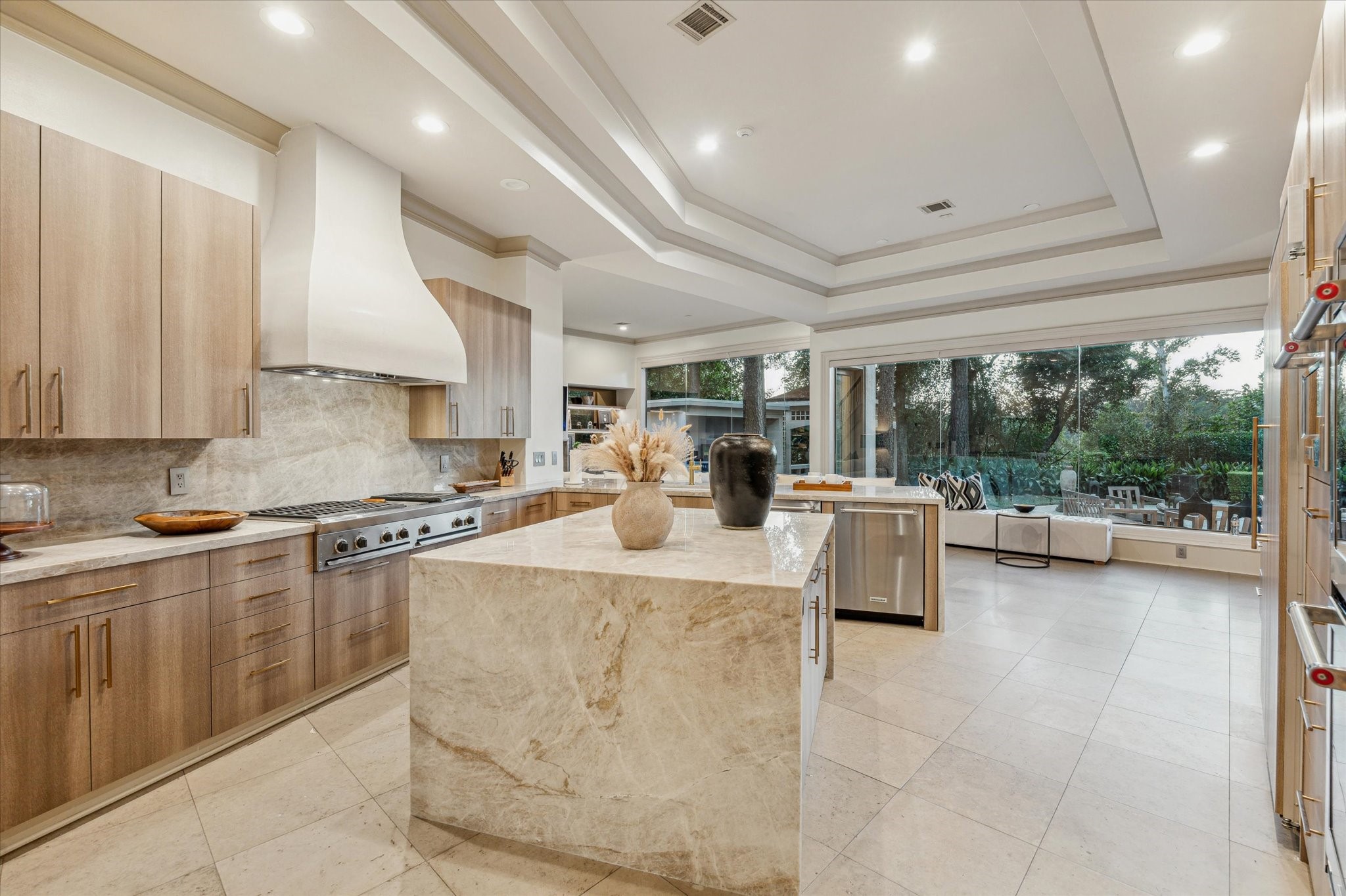 918 Huntington Cove Houston, TX 77063 - Photo 28 of 50 A sleek modern kitchen is anchored by this elegant center island, TajMahal marble waterfall edges and one of the main visual attraction of the kitchen