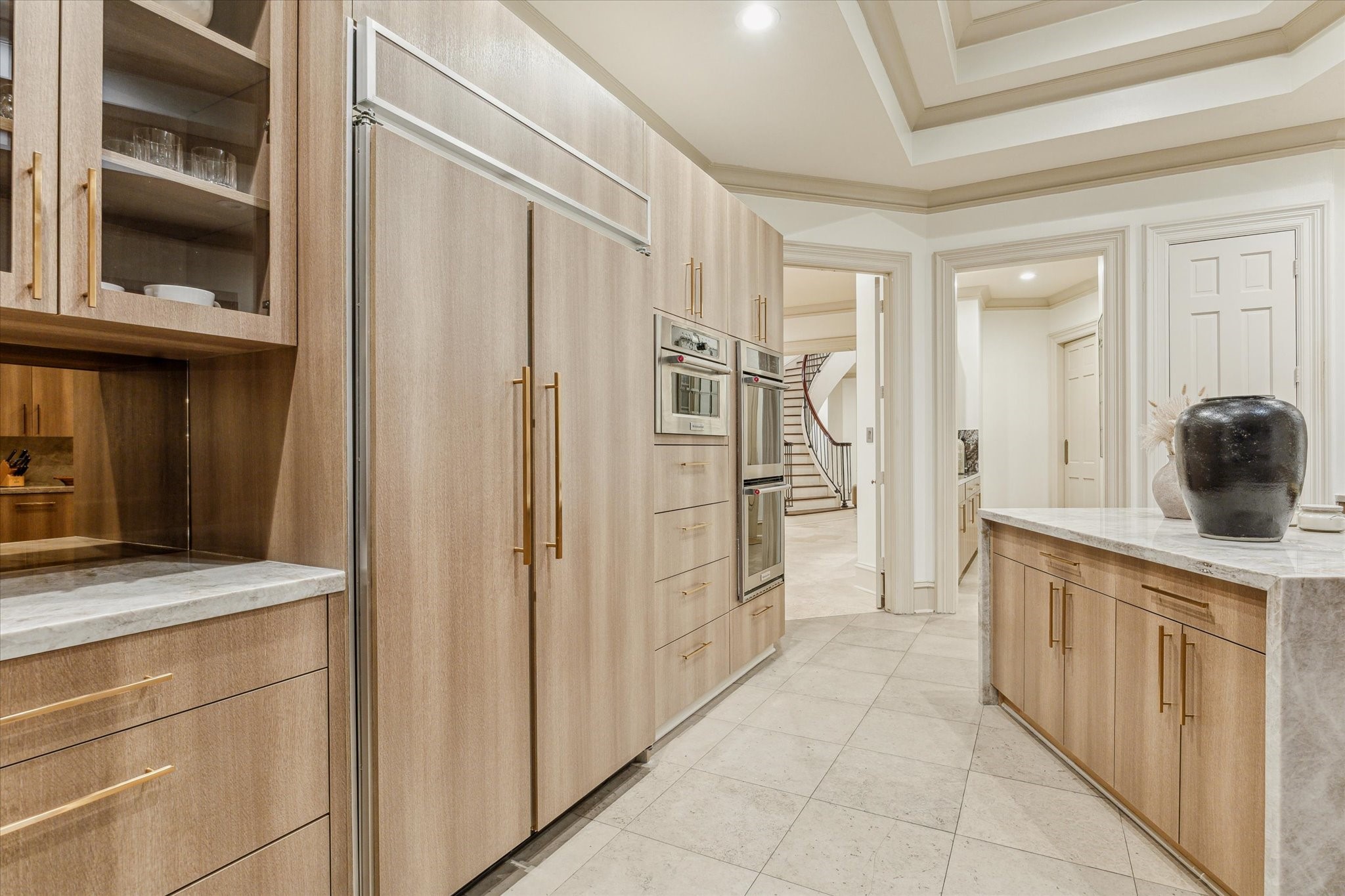 918 Huntington Cove Houston, TX 77063 - Photo 31 of 50 The kitchen offers a streamlined sophisticated look with double dishwashers, coffee bar with bronzed mirror backsplash, paneled refrigerator that disappears into the custom-built cabinetry, crating a continuous line of abundant storage.