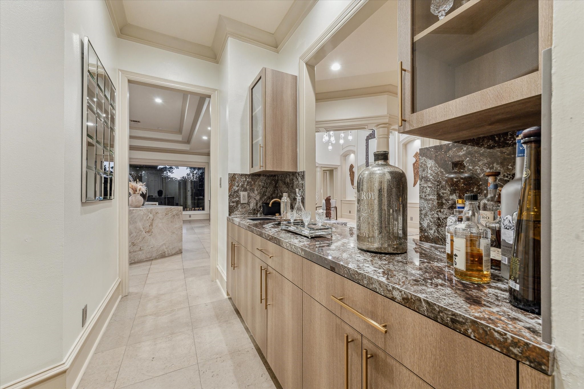 918 Huntington Cove Houston, TX 77063 - Photo 33 of 50 Enhancing your gatherings, a stylish wet bar porcelain countertop and glass front cabinetry. Perfectly situated offering seamless transitioning between the dinning room and the kitchen.