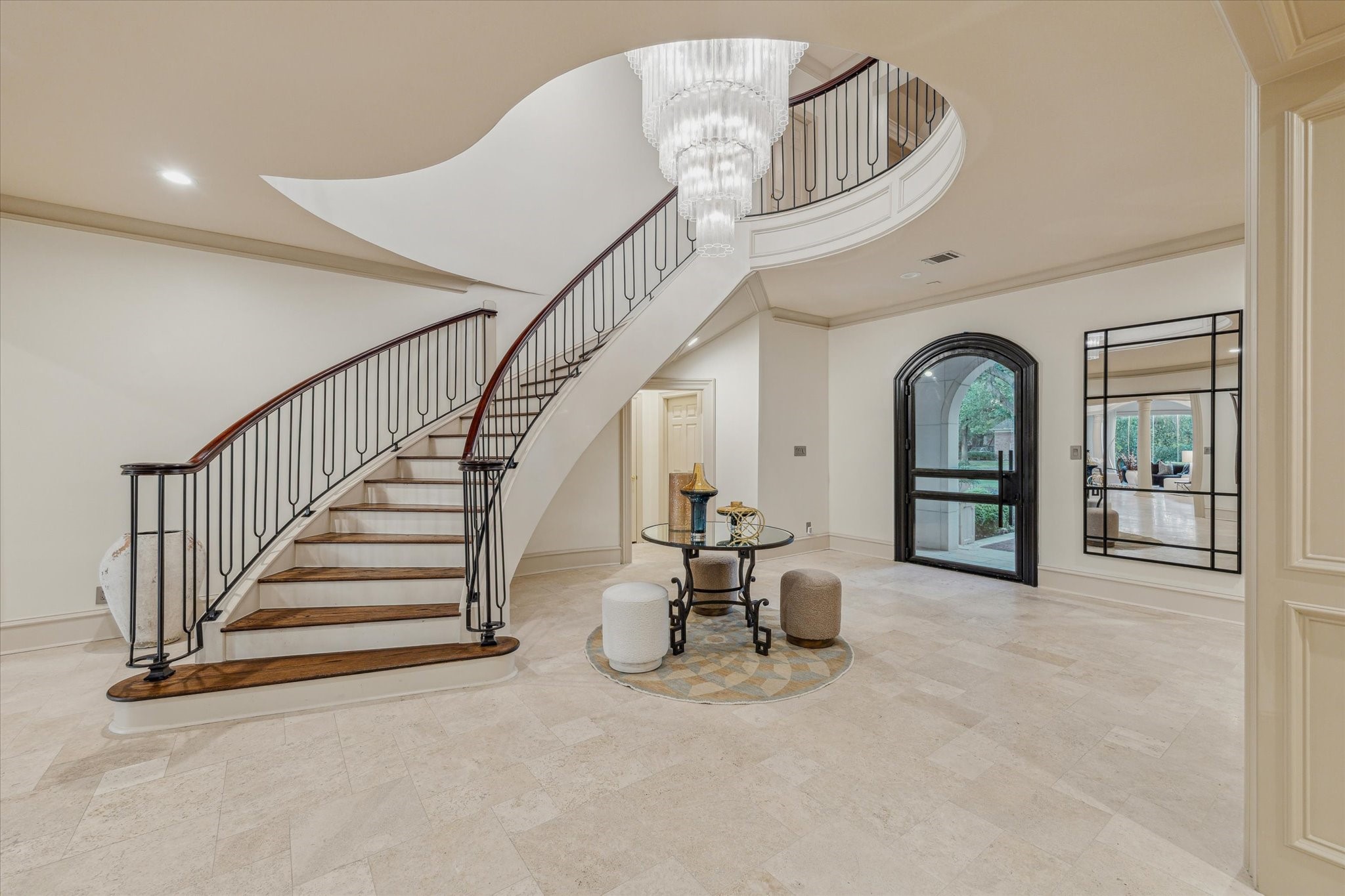 918 Huntington Cove Houston, TX 77063 - Photo 5 of 50 Upon entry, your guests are greeted by a grand foyer showcasing a sweeping dramatic staircase and dazzling crystal hanging chandelier