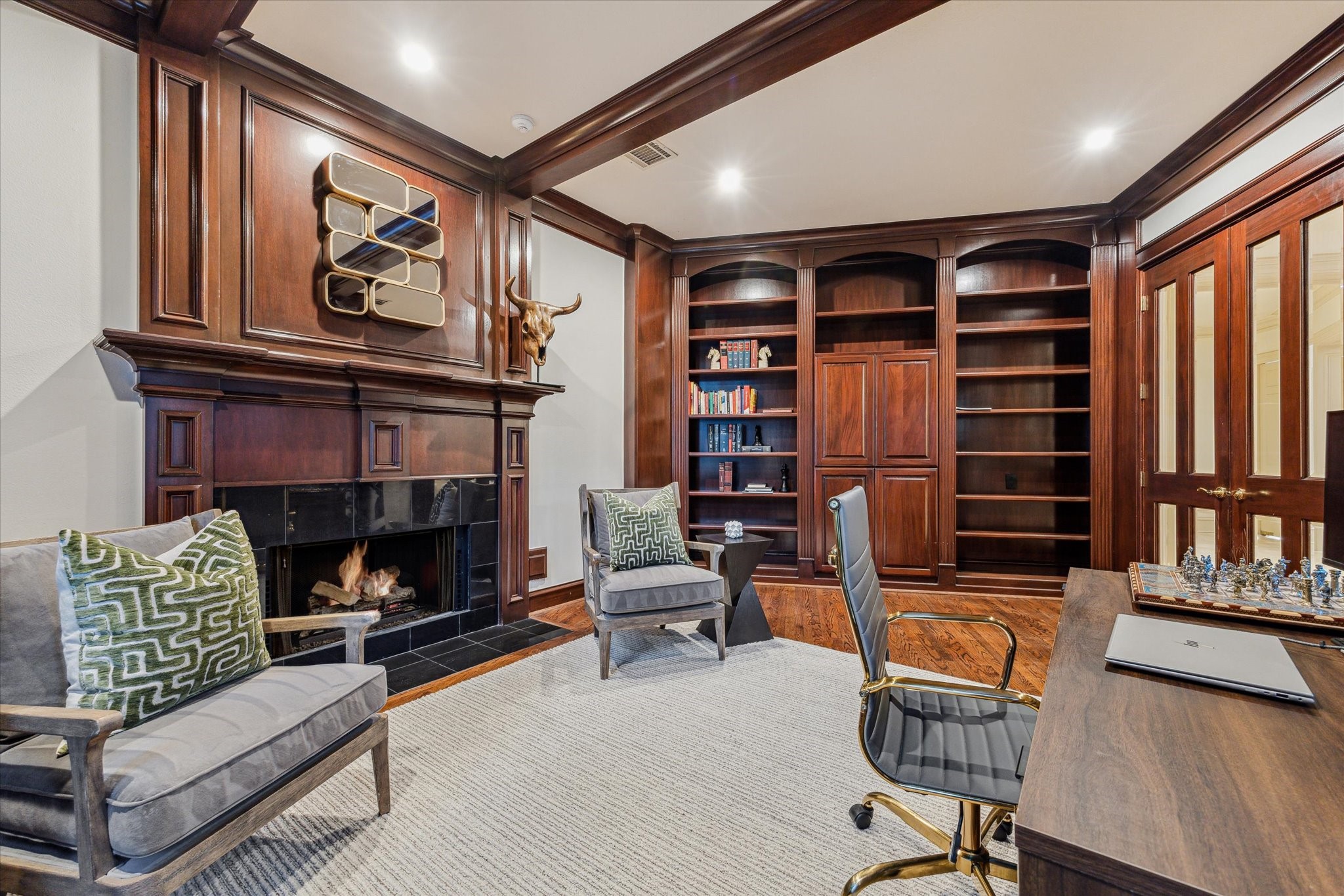 918 Huntington Cove Houston, TX 77063 - Photo 6 of 50 Immediately to the left of the main foyer and through double French doors, is a private library or home office, complete with a cozy fireplace and custom-built book shelves.
