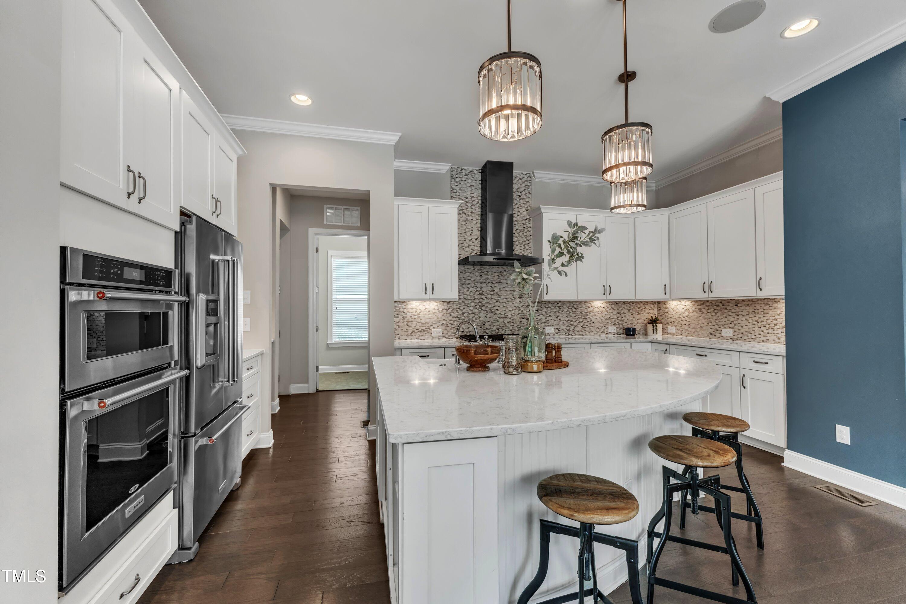 8121 Greys Landing Way Raleigh, NC 27615 - Photo 14 of 95 a kitchen with stainless steel appliances granite countertop a stove refrigerator and cabinets