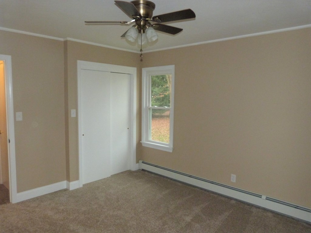1463 Pittsburgh Road Franklin, PA 16323 - Photo 18 of 32 an empty room with a window and a fan
