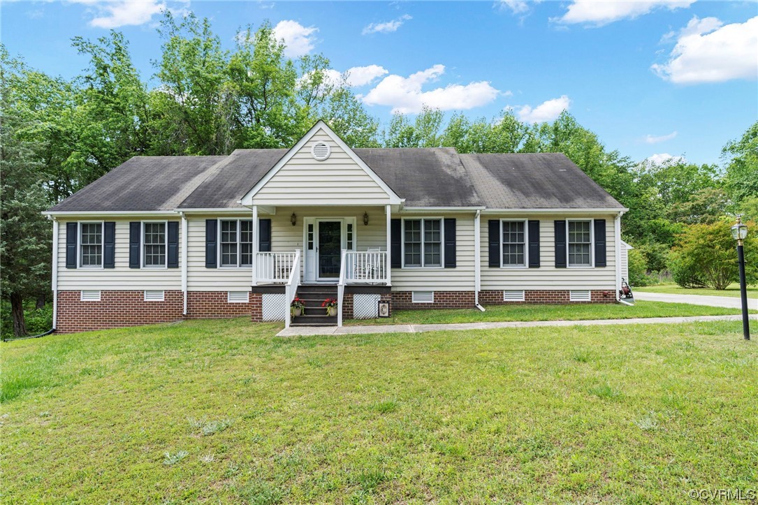 3963 Doe Run Road Hopewell, VA 23860 - Photo 1 of 48 a front view of a house with a garden and trees