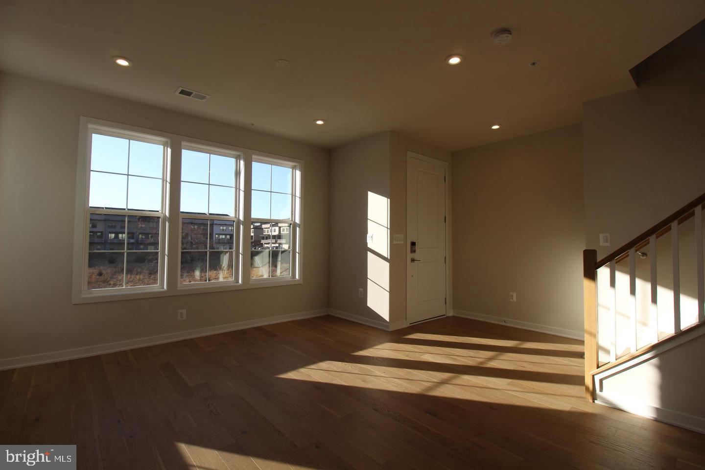 22383 Roanoke Rise Terrace Ashburn, VA 20148 - Photo 9 of 41 a view of empty room with wooden floor and fan