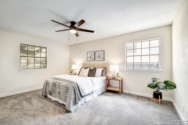 a spacious bedroom with a bed and a window