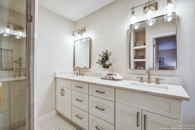 a bathroom with double sink and a mirror