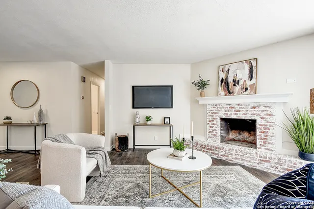 a living room with furniture and a fireplace