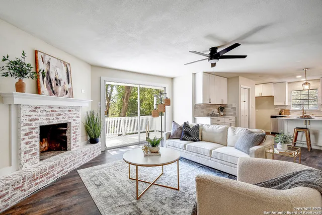 a living room with furniture and a fireplace