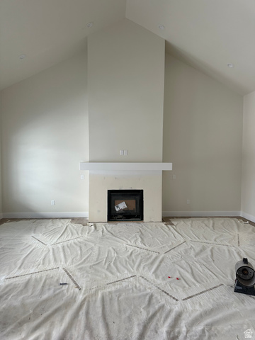 143 South Chamberlain Street, Unit 327 Mapleton, UT 84664 - Photo 4 of 12 Unfurnished living room featuring a high ceiling and a premium fireplace