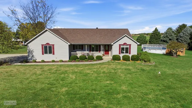 a front view of house with yard and green space