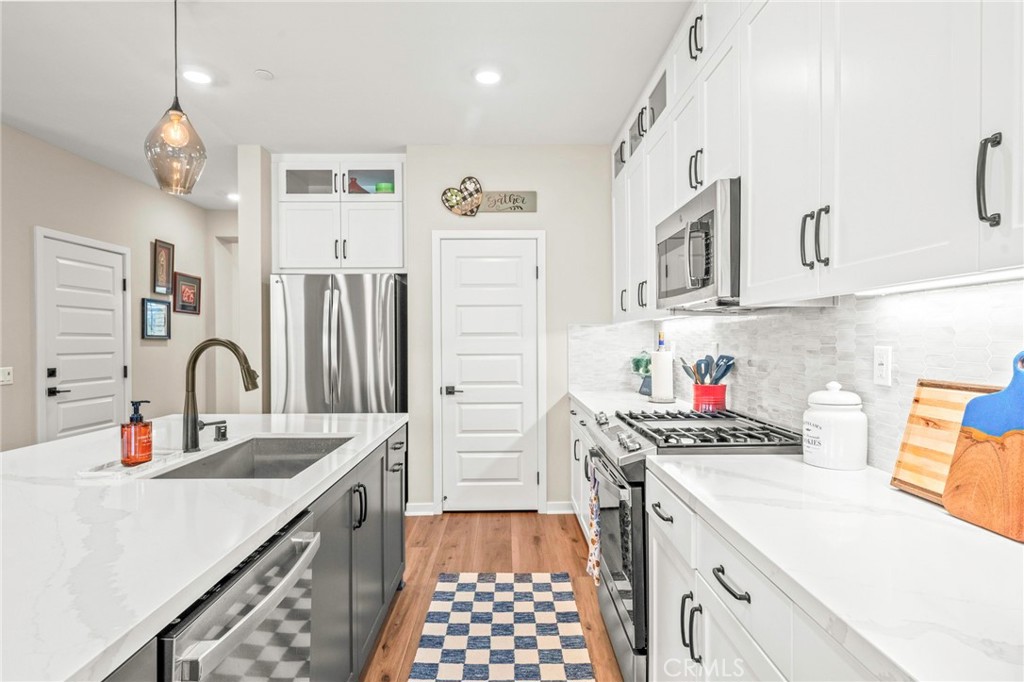 1281 Roots Way Rancho Mission Viejo, CA 92694 - Photo 16 of 75 a kitchen with stainless steel appliances a sink stove and refrigerator