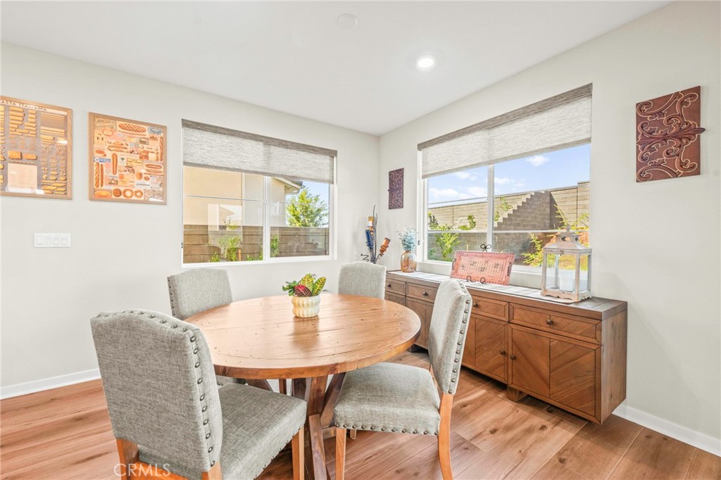 1281 Roots Way Rancho Mission Viejo, CA 92694 - Photo 21 of 75 a view of a dining room with furniture and wooden floor