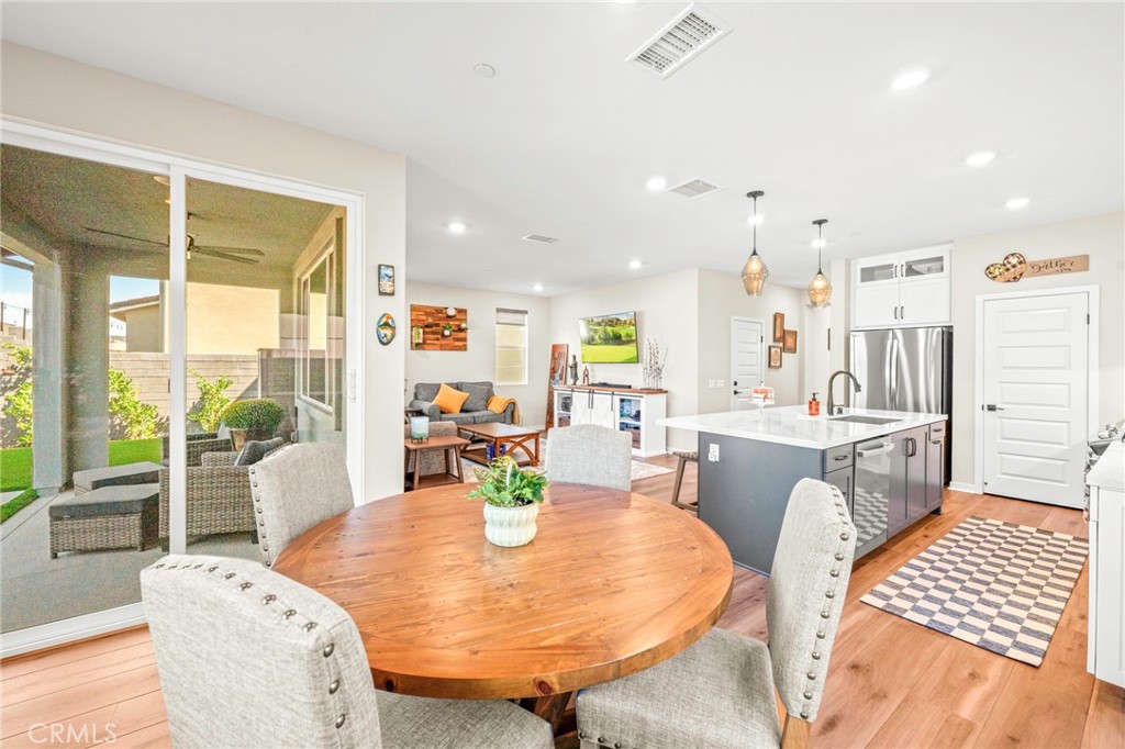 1281 Roots Way Rancho Mission Viejo, CA 92694 - Photo 22 of 75 a dining room with furniture a large window and wooden floor