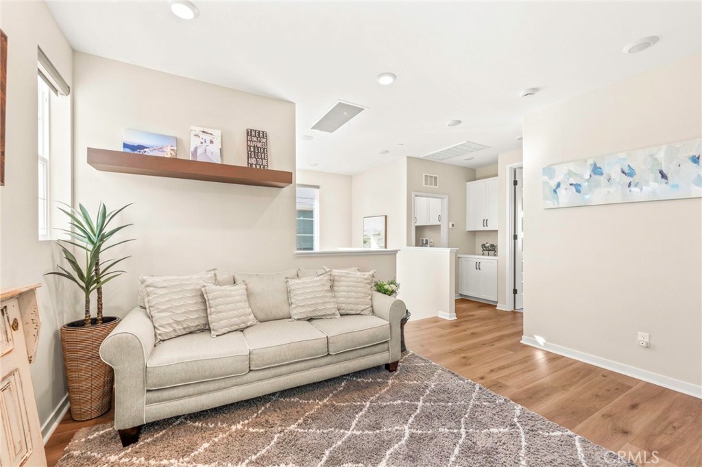 1281 Roots Way Rancho Mission Viejo, CA 92694 - Photo 29 of 75 a living room with furniture and a painting on the wall