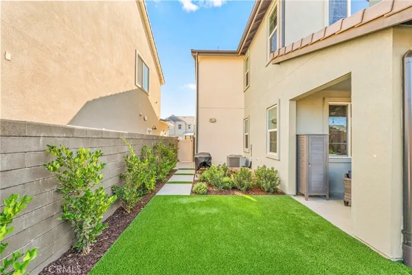 a backyard of a house with table and chairs
