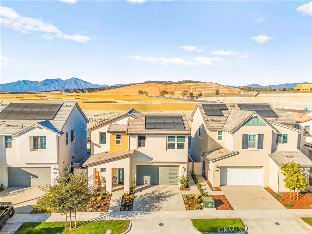 1281 Roots Way Rancho Mission Viejo, CA 92694 - Photo 10 of 75 a view of a white house with a big yard and potted plants
