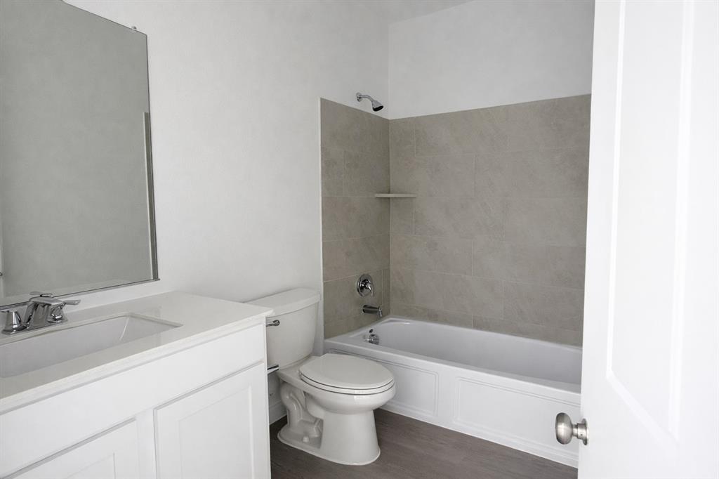 6420 Ponderosa Pne Road McKinney, TX 75071 - Photo 5 of 10 Full bathroom with vanity, washtub / shower combination, and dark wood-type flooring