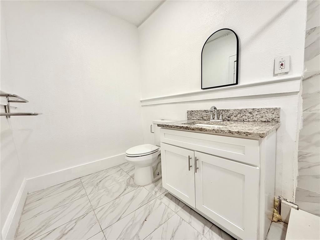 507 North Ridgewood Avenue, Unit 4 Daytona Beach, FL 32114 - Photo 6 of 7 a bathroom with a sink and a toilet