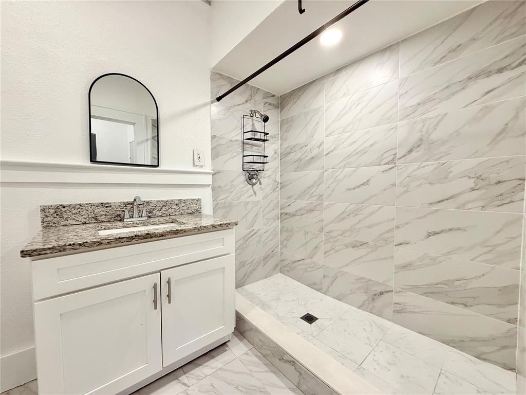 507 North Ridgewood Avenue, Unit 4 Daytona Beach, FL 32114 - Photo 7 of 7 a bathroom with a sink and a mirror