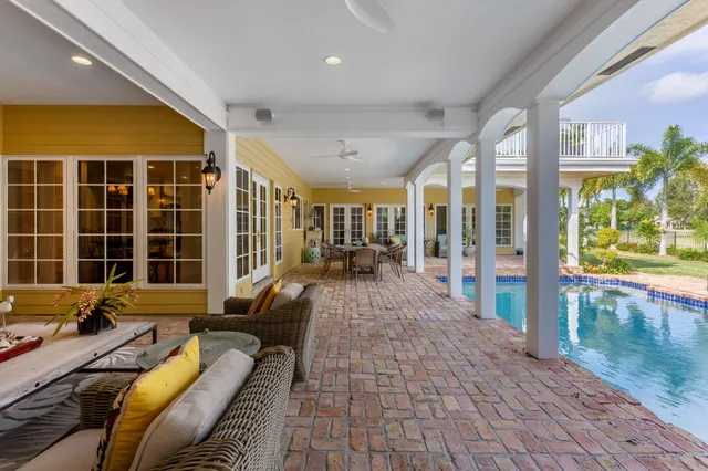 a view of a patio with couple of chairs and a fountain