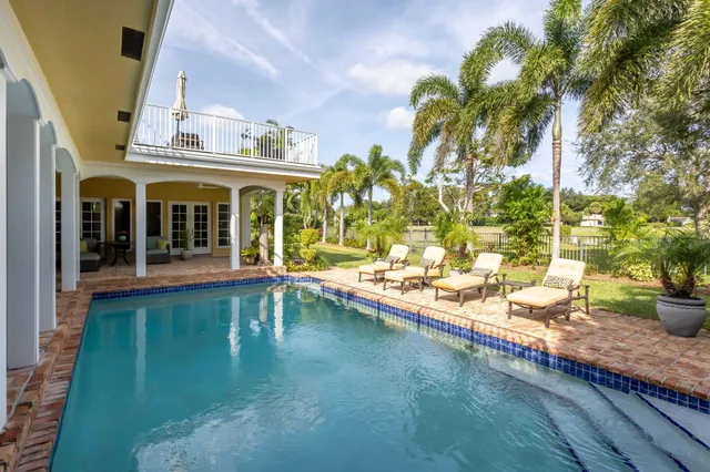 a view of a house with backyard and sitting area