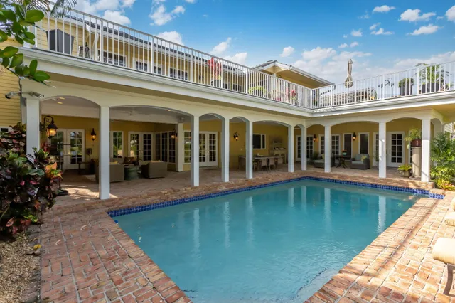 a view of a patio with table and chairs and potted plants