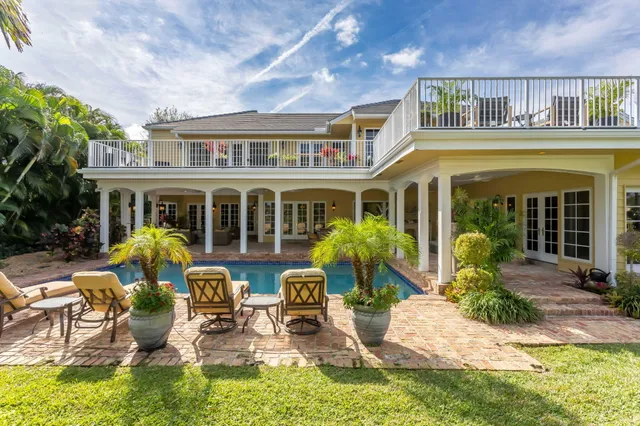 a dining room with furniture a chandelier and wooden floor