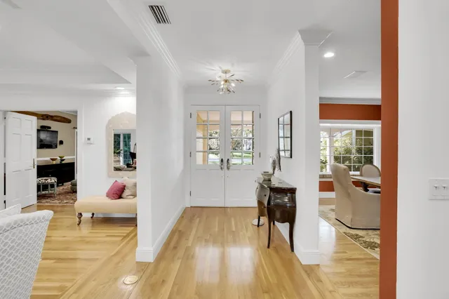 a living room with furniture and a dining table with kitchen view