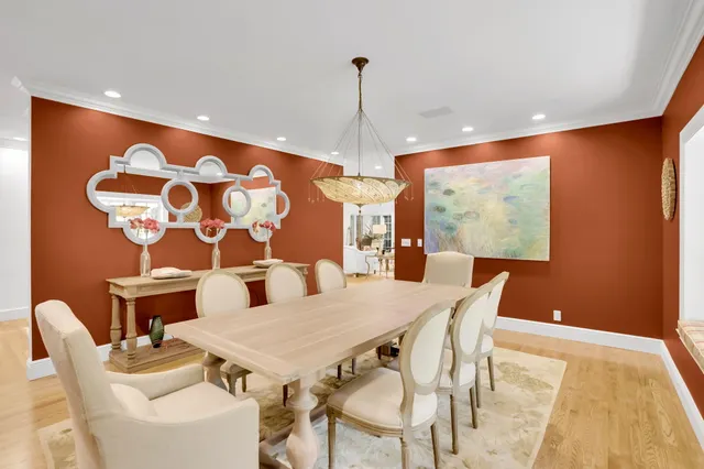 a living room with furniture and floor to ceiling windows