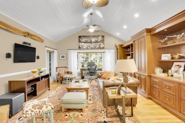 a bedroom with a bed and a flat tv screen on wall