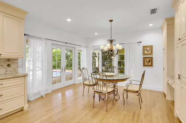 a living room with furniture two window and a ceiling fan