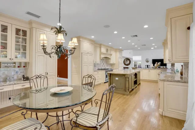 a bathroom with a granite countertop sink mirror vanity and toilet