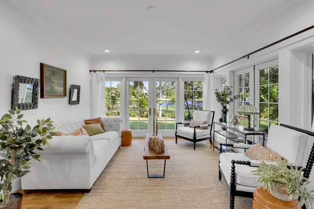a living room with furniture flat screen tv and wooden floor