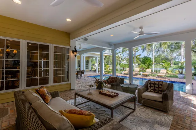a view of a patio with table and chairs potted plants with wooden floor