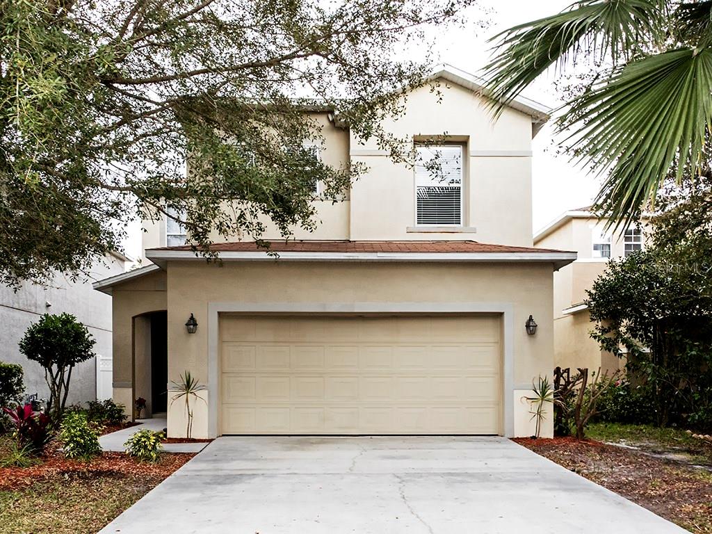 2348 Spring Hollow Loop Wesley Chapel, FL 33544 - Photo 1 of 1 a house that has a tree in front of the house