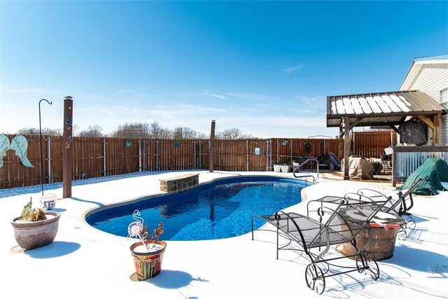 a view of a swimming pool with a lounge chairs