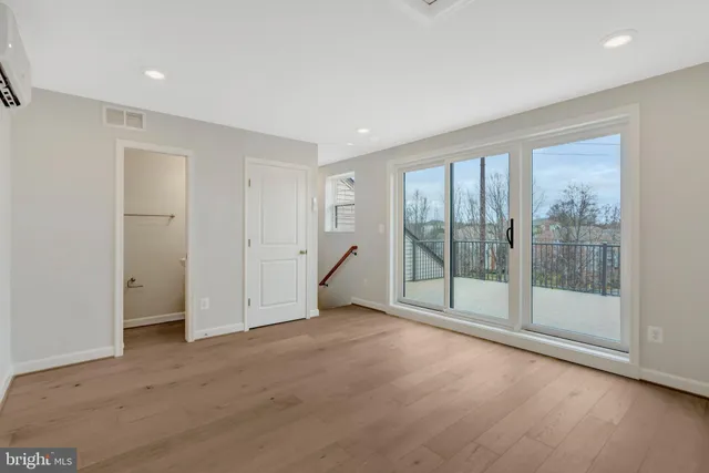 a view of an empty room with glass door